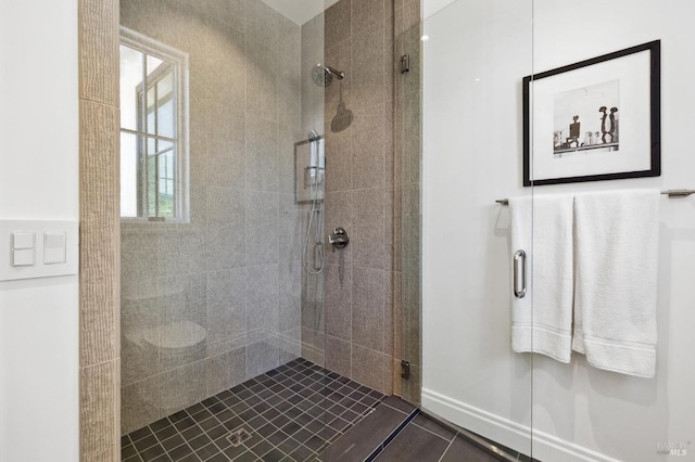 bathroom featuring a shower with shower door and tile patterned floors