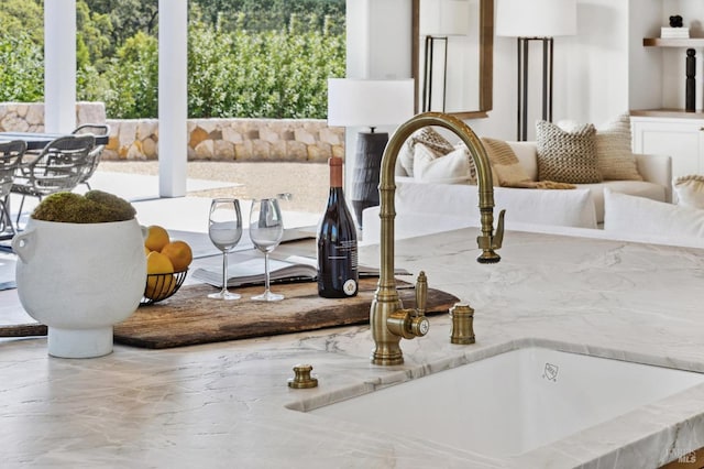 room details featuring sink and white cabinetry