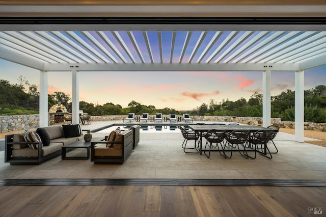 patio terrace at dusk featuring an outdoor hangout area and a pergola