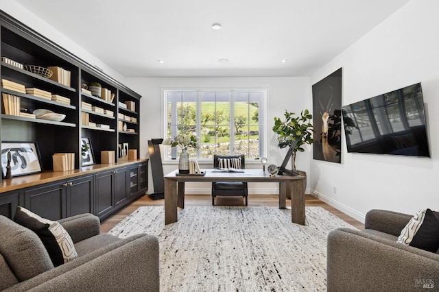 office with light hardwood / wood-style flooring