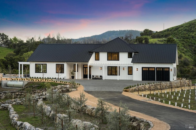 modern farmhouse style home featuring a mountain view and a garage