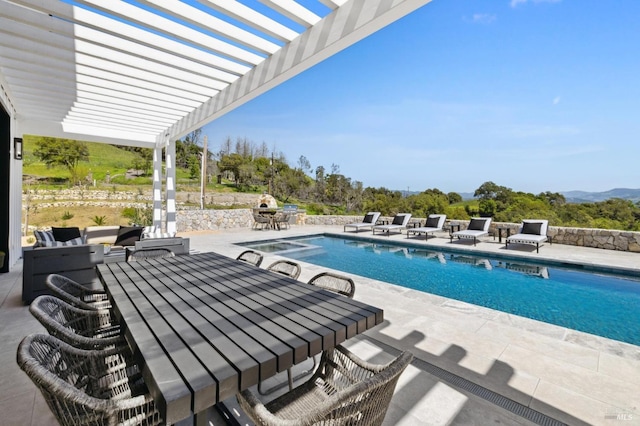 view of swimming pool featuring a pergola and a patio