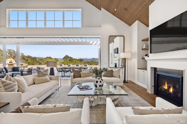 living room featuring hardwood / wood-style flooring, wood ceiling, and vaulted ceiling