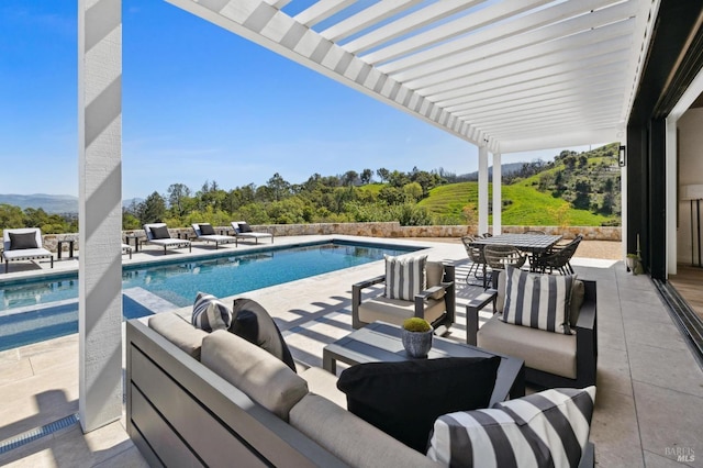 view of swimming pool with a pergola, outdoor lounge area, and a patio