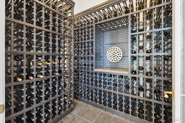 wine area featuring tile patterned floors