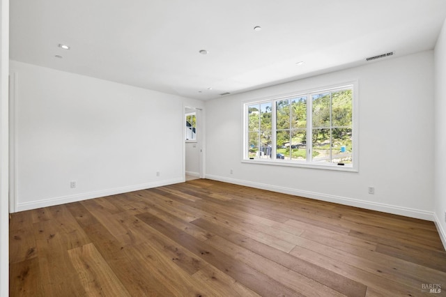 spare room featuring hardwood / wood-style floors