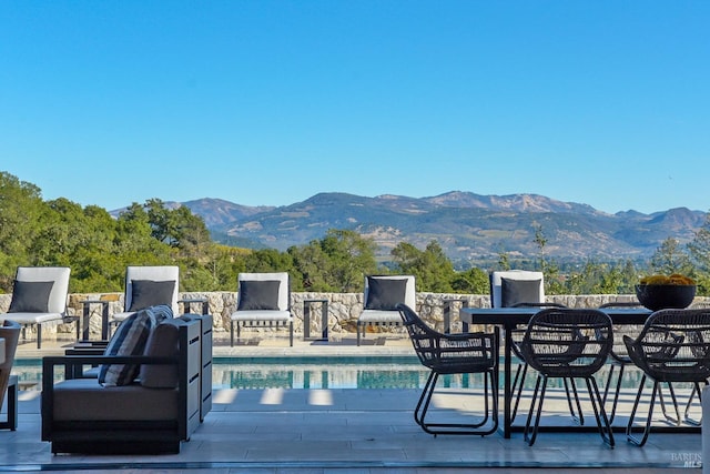 view of swimming pool with a mountain view