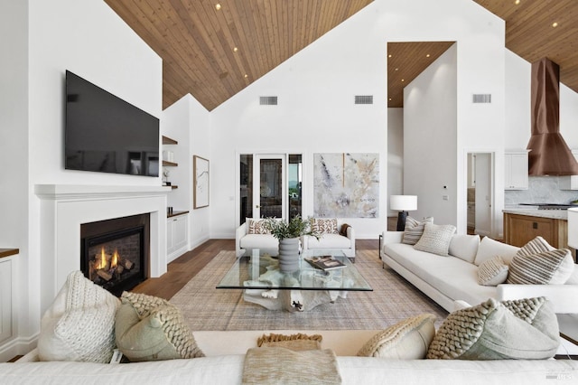 living room featuring built in shelves, wood ceiling, wood-type flooring, and high vaulted ceiling