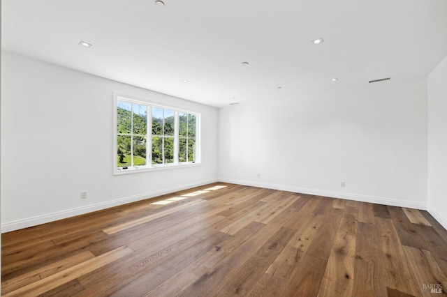 unfurnished room with hardwood / wood-style floors