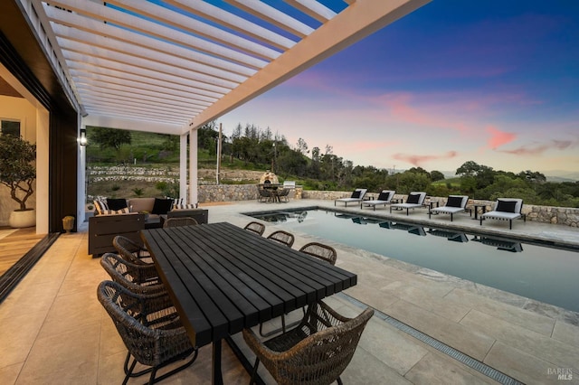 patio terrace at dusk with a pergola