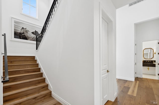 stairs featuring hardwood / wood-style floors