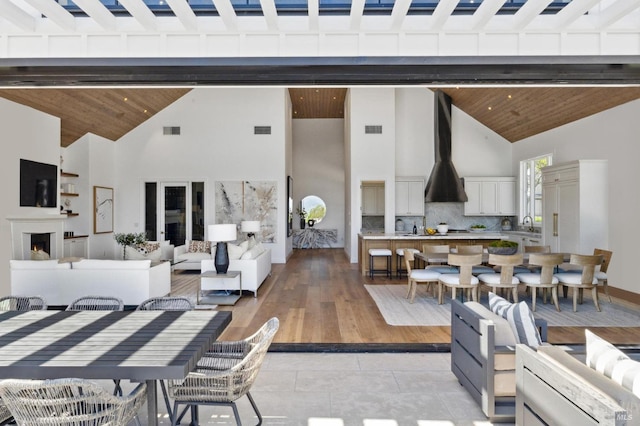 interior space with high vaulted ceiling, wooden ceiling, and beamed ceiling