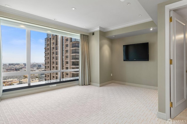 unfurnished room featuring plenty of natural light, light colored carpet, and ornamental molding