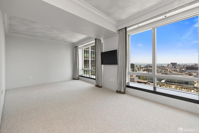 unfurnished living room featuring a healthy amount of sunlight, carpet floors, and crown molding