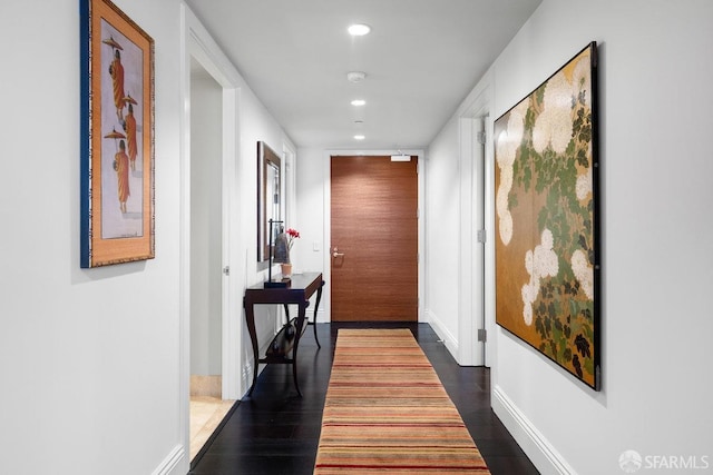 hall with dark wood-type flooring