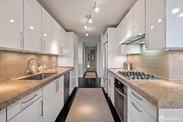 kitchen with sink, ventilation hood, white cabinetry, appliances with stainless steel finishes, and dark hardwood / wood-style flooring