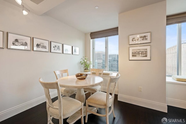 dining area featuring dark hardwood / wood-style flooring