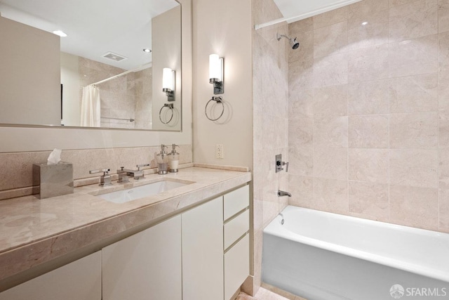 bathroom featuring vanity and shower / bathtub combination with curtain