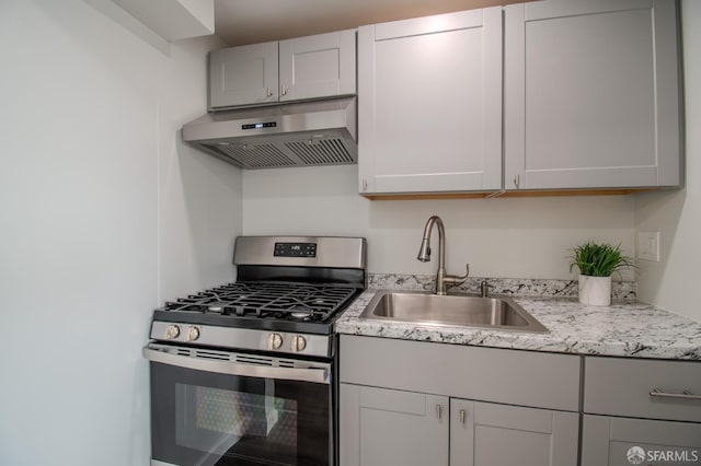 1579 46th Ave, San Francisco, CA 94122 - kitchen with range hood, stainless steel gas stove, and light stone countertops