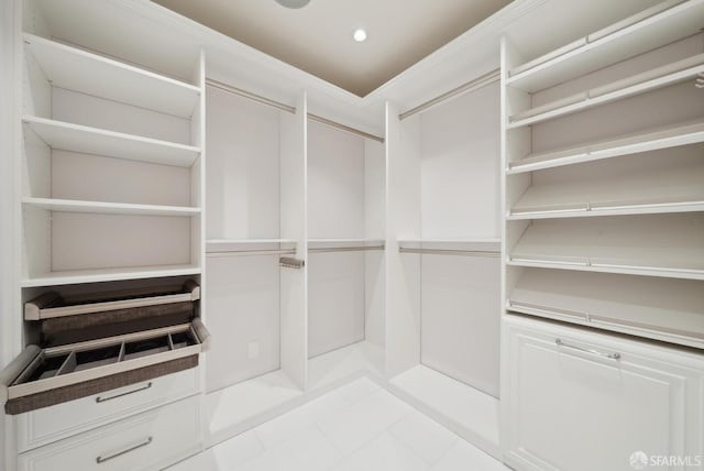 spacious closet with light tile patterned floors