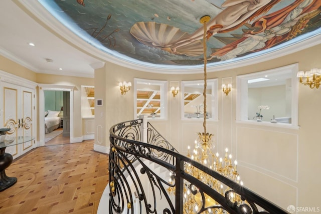 hallway with a chandelier, ornamental molding, an upstairs landing, baseboards, and recessed lighting