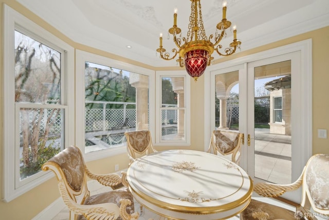dining room featuring a chandelier, healthy amount of natural light, and ornamental molding