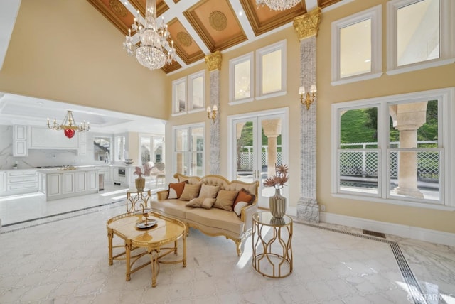 living room featuring a chandelier, a high ceiling, inlaid floor details, baseboards, and coffered ceiling
