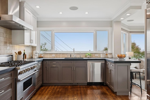 1983 15th Ave, San Francisco, CA 94116 - kitchen with appliances with stainless steel finishes, wall chimney range hood, dark countertops, healthy amount of natural light, and crown molding