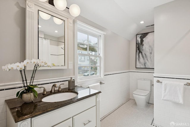 1983 15th Ave, San Francisco, CA 94116 - bathroom with tile walls, vanity, wainscoting, lofted ceiling, and tile patterned flooring
