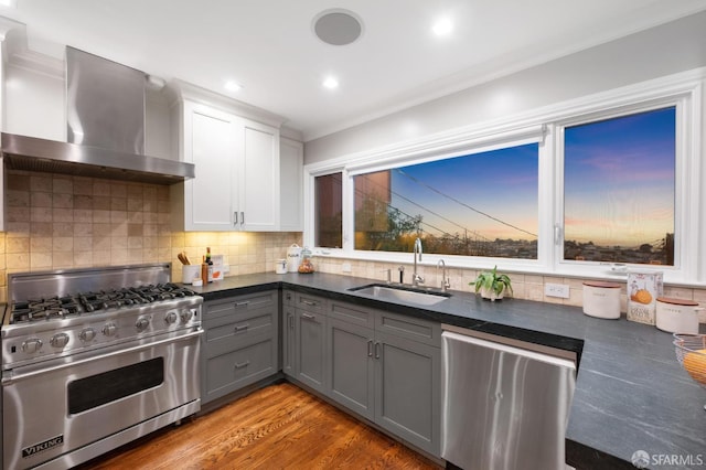 1983 15th Ave, San Francisco, CA 94116 - kitchen with stainless steel appliances, wall chimney exhaust hood, gray cabinets, dark countertops, and tasteful backsplash