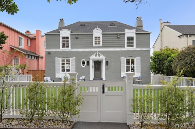 1983 15th Ave, San Francisco, CA 94116 - view of front of house featuring a fenced front yard, a chimney, stucco siding, and a shingled roof