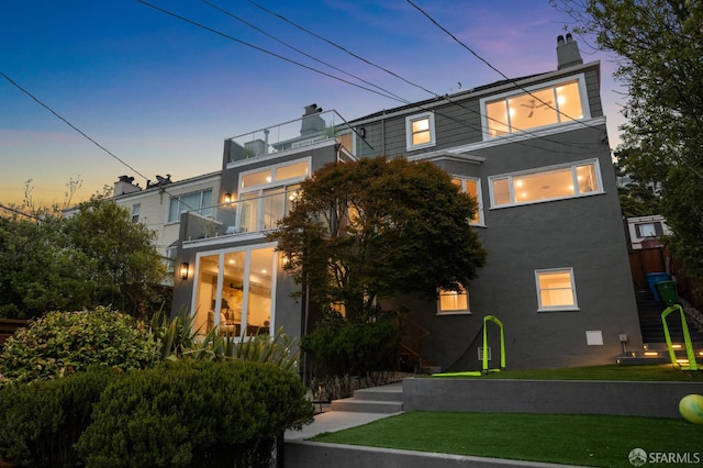 1983 15th Ave, San Francisco, CA 94116 - view of front of home with a balcony, a chimney, a lawn, and stucco siding