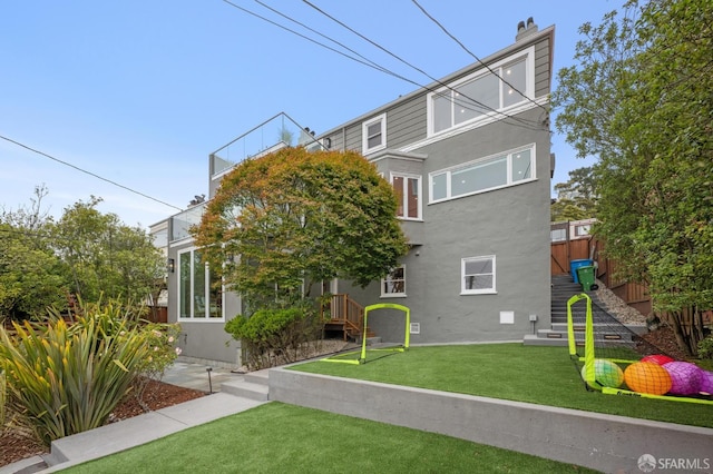1983 15th Ave, San Francisco, CA 94116 - back of property with stucco siding, a chimney, and a yard