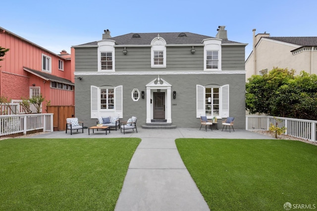 1983 15th Ave, San Francisco, CA 94116 - rear view of house featuring outdoor lounge area, a fenced backyard, a chimney, and a patio area