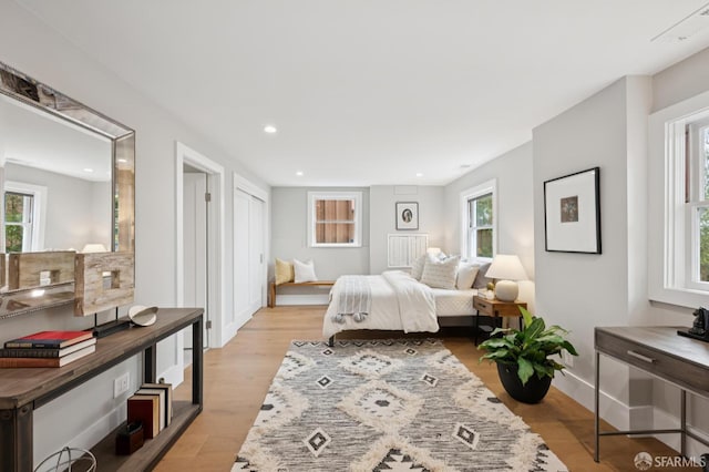 1983 15th Ave, San Francisco, CA 94116 - bedroom with multiple windows, recessed lighting, and light wood-type flooring