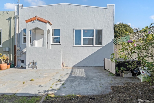 rear view of property featuring a patio