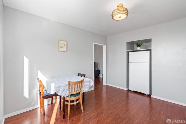 dining space with dark hardwood / wood-style flooring