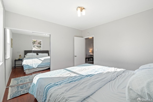 bedroom featuring a closet and dark hardwood / wood-style floors