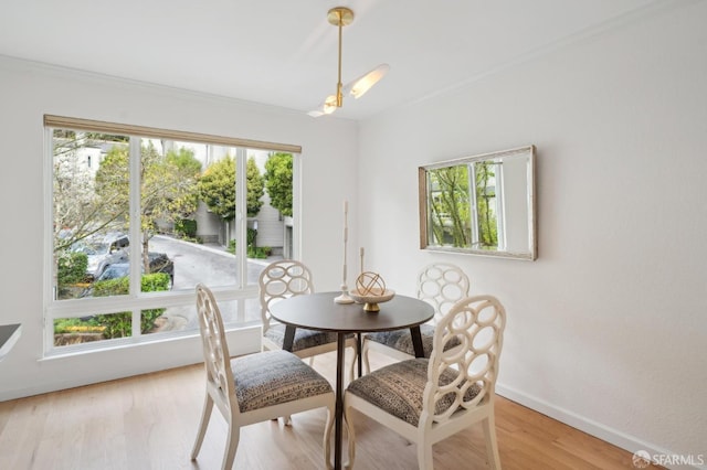 dining room with light wood-type flooring and baseboards