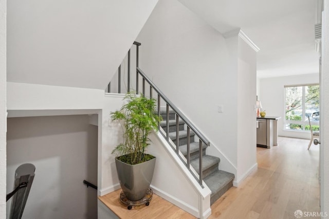 stairs featuring baseboards and wood finished floors