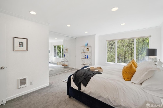 carpeted bedroom featuring baseboards, recessed lighting, visible vents, and crown molding