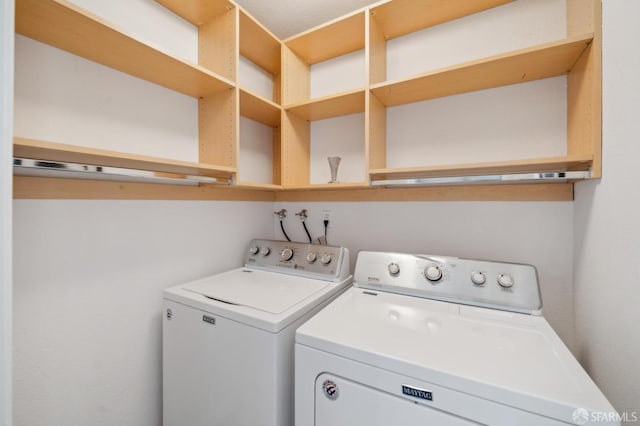 clothes washing area featuring laundry area and independent washer and dryer