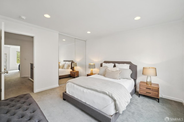 bedroom with baseboards, a closet, ornamental molding, and carpet flooring