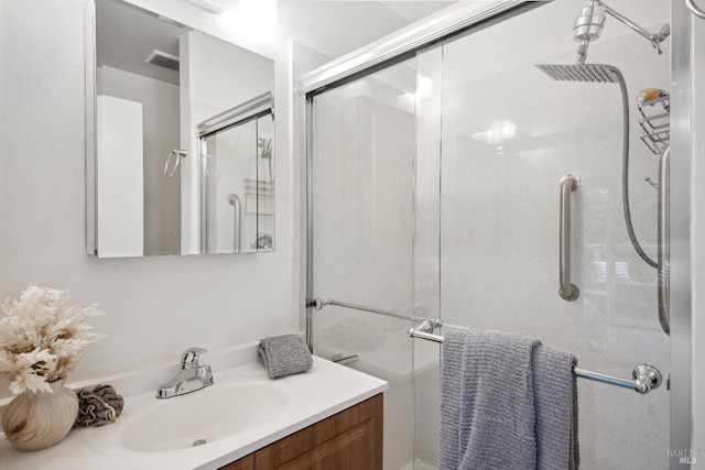 bathroom featuring vanity and a shower with shower door