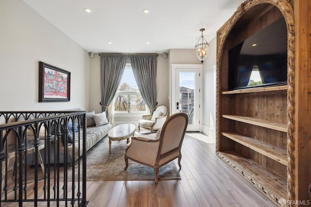 living room featuring a chandelier and hardwood / wood-style flooring