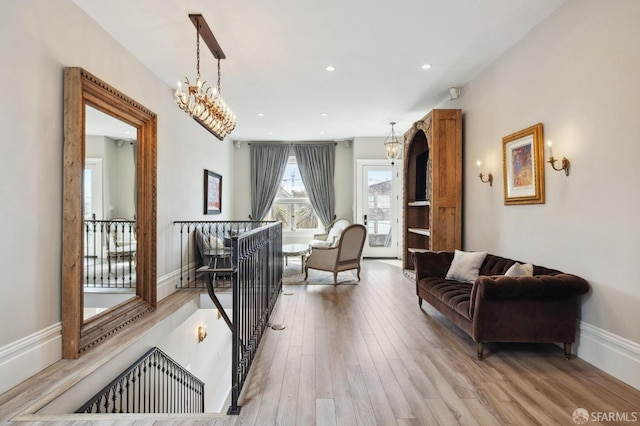 living room with an inviting chandelier and hardwood / wood-style flooring