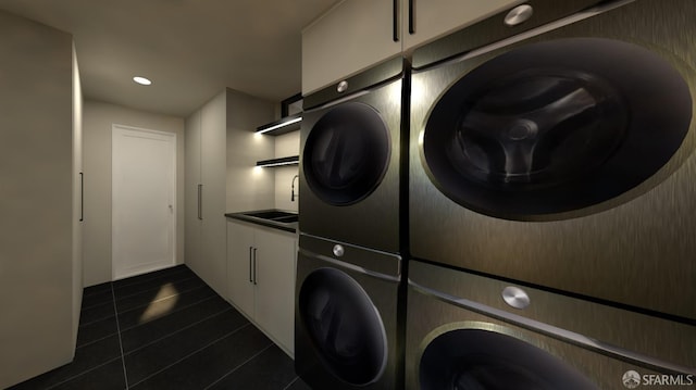 clothes washing area with stacked washer and dryer, sink, dark tile patterned flooring, and cabinets