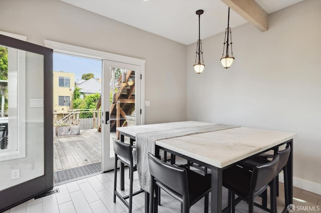 dining space with beam ceiling