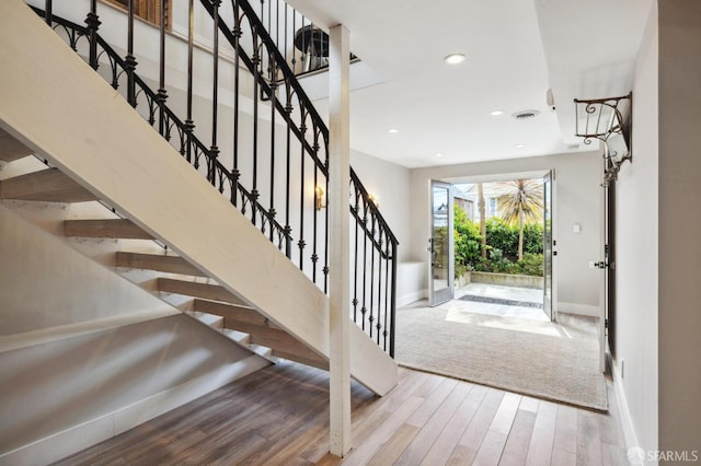 entryway with hardwood / wood-style floors