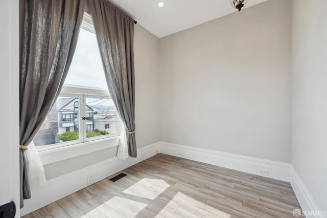 spare room featuring light hardwood / wood-style floors